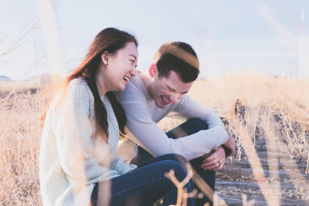 Pareja joven abrazándose y sonriendo con complicidad, simbolizando cómo una autoestima sólida favorece relaciones felices y equilibradas.